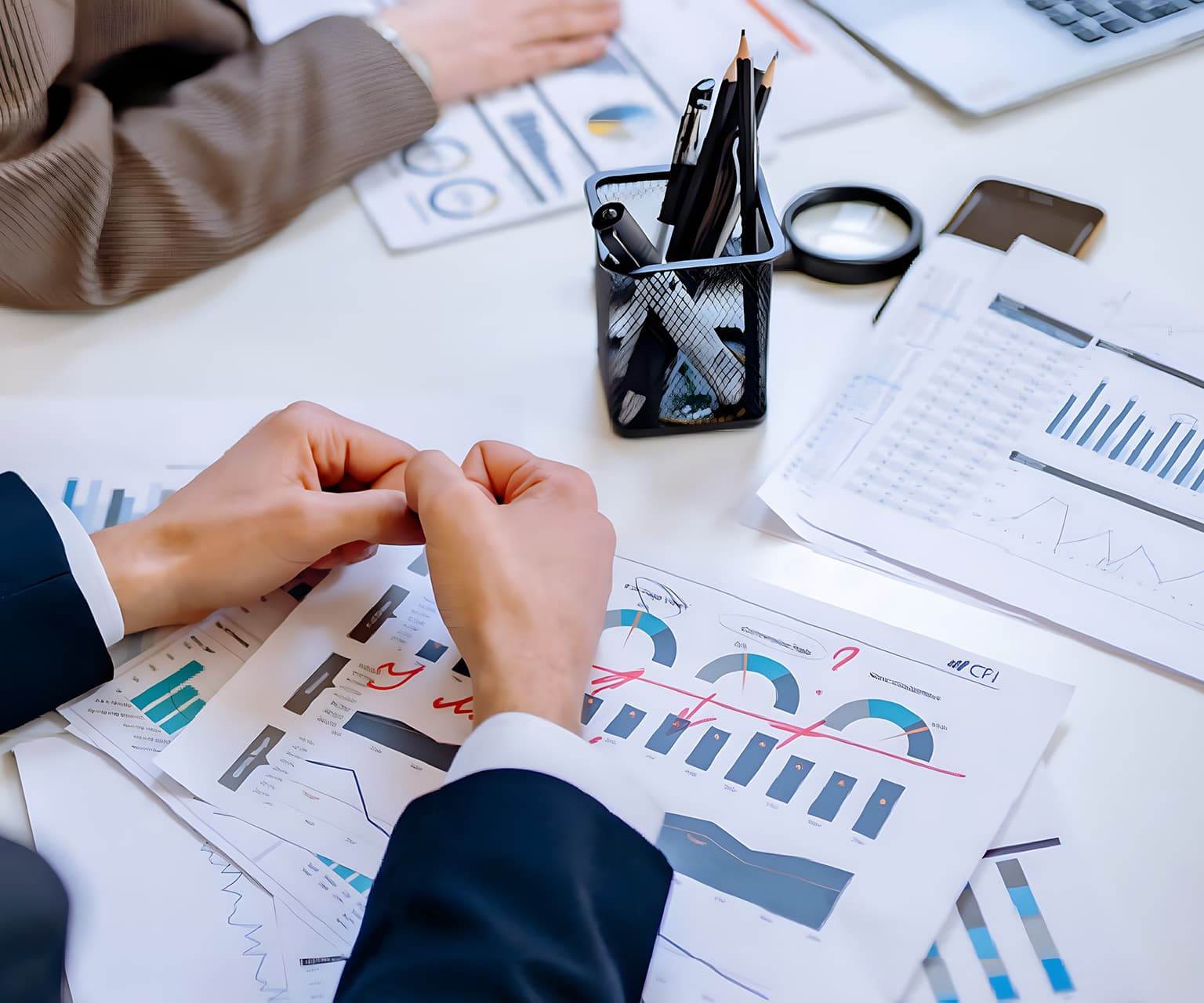 Análisis de informes financieros y gráficos de datos en una mesa de trabajo.